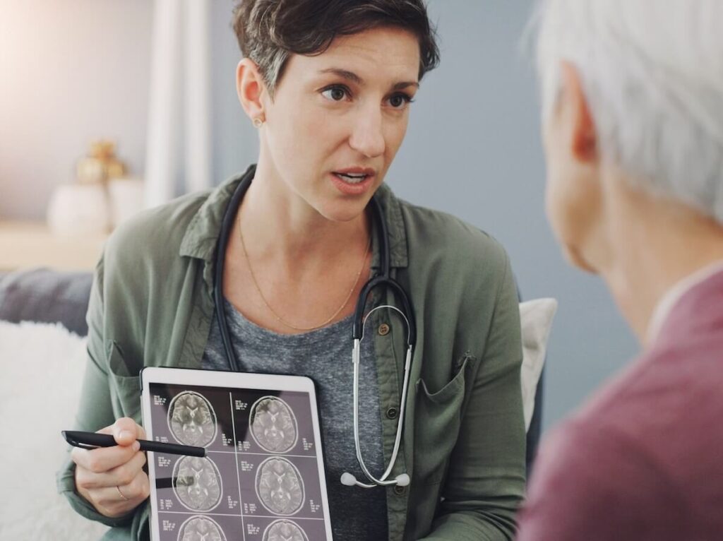 Doctor showing a brain scan to a senior