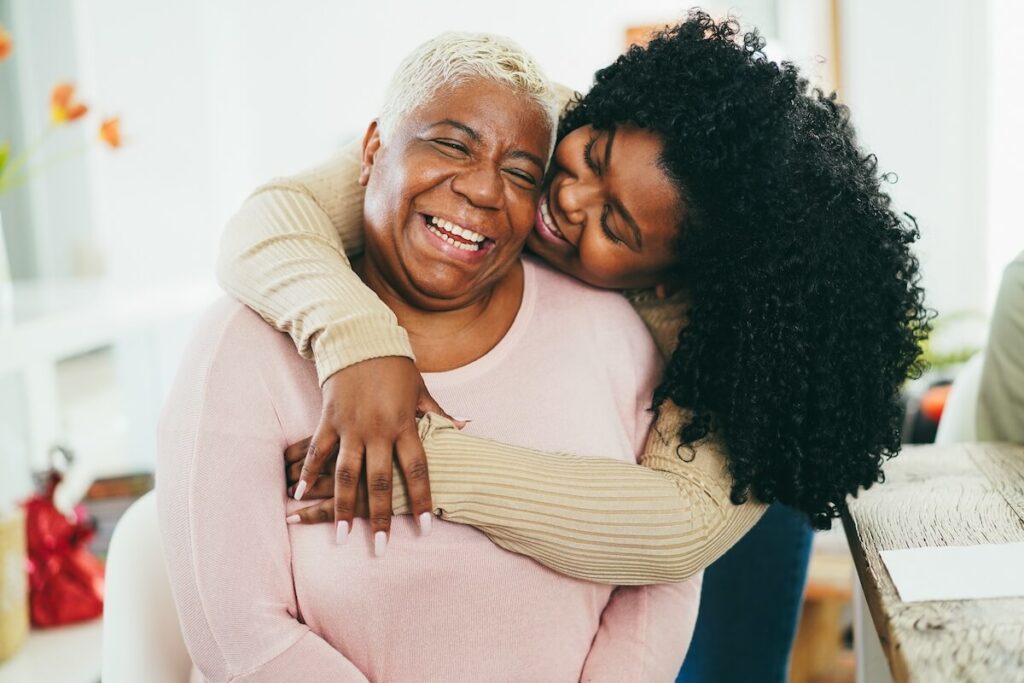 Adult daughter hugging her elderly mother