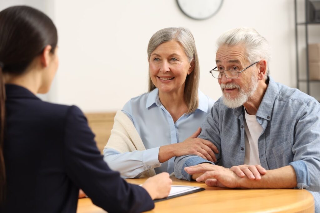 A couple of seniors discussing something with a senior living rep