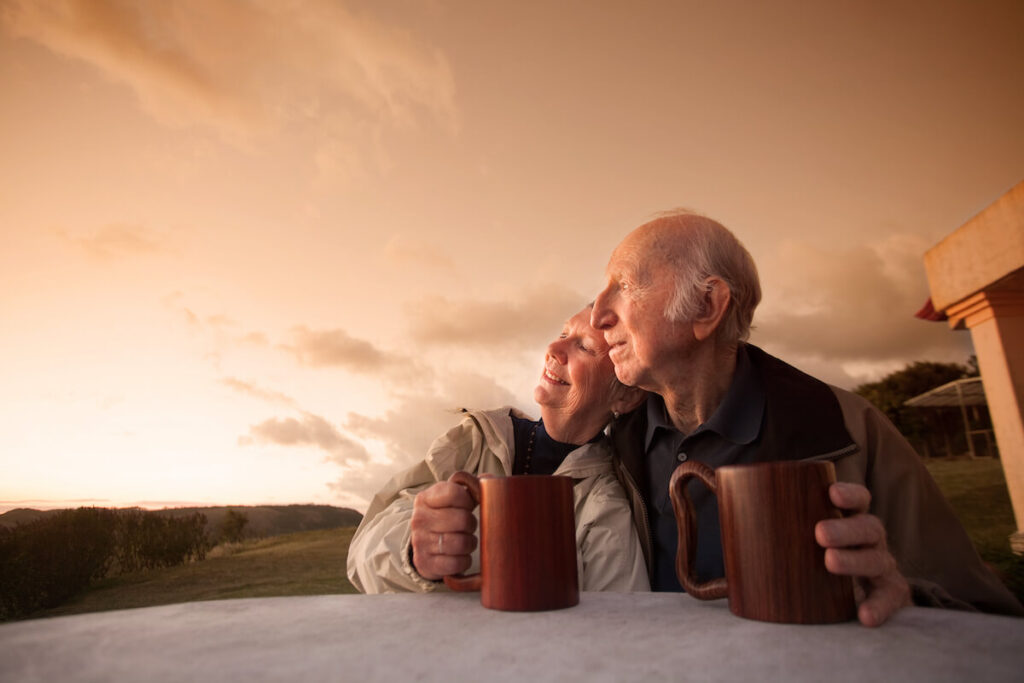 A senior couple looking at the sunset