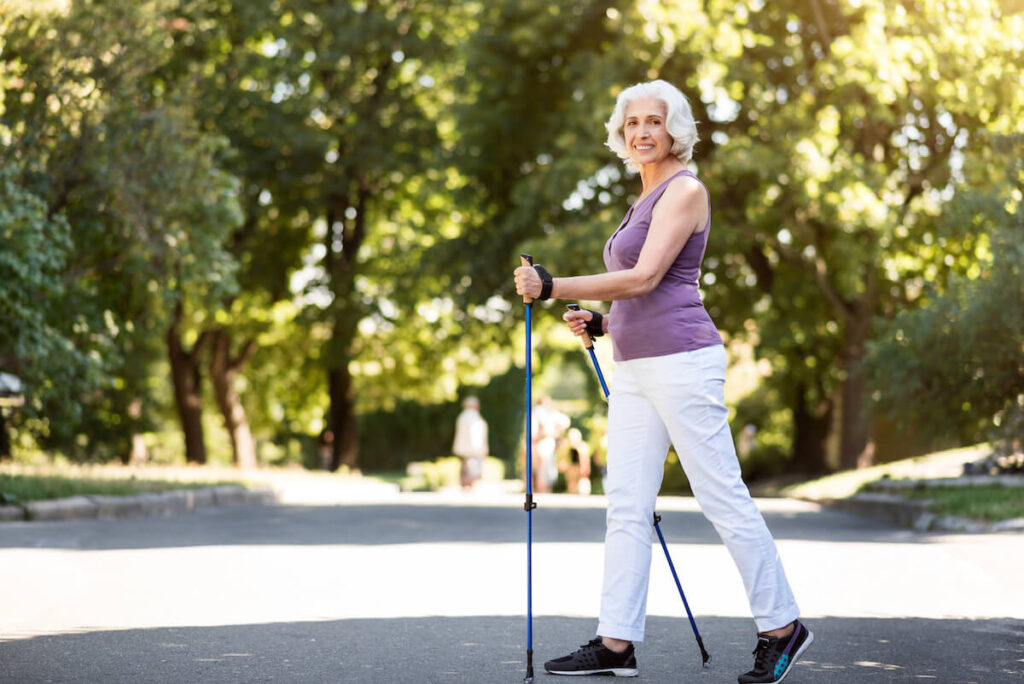 Smiling older woman power walking in Florida
