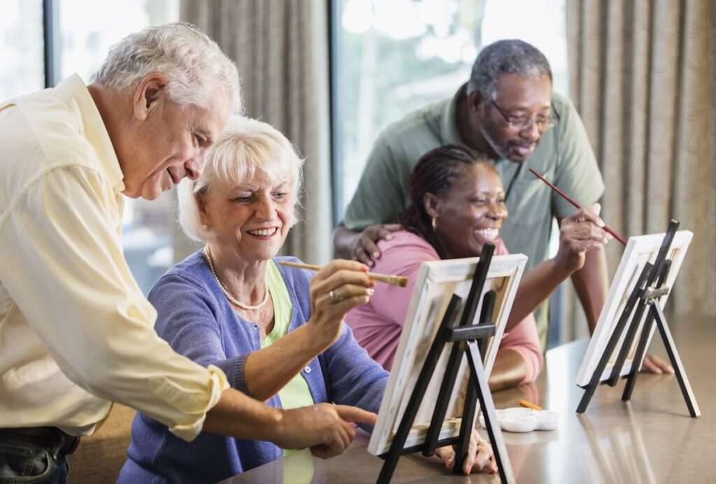 group of seniors paint together