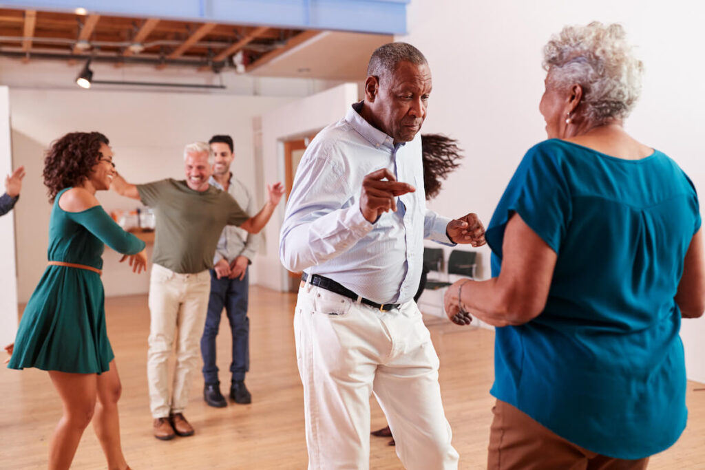 Group of seniors dancing in a senior living community