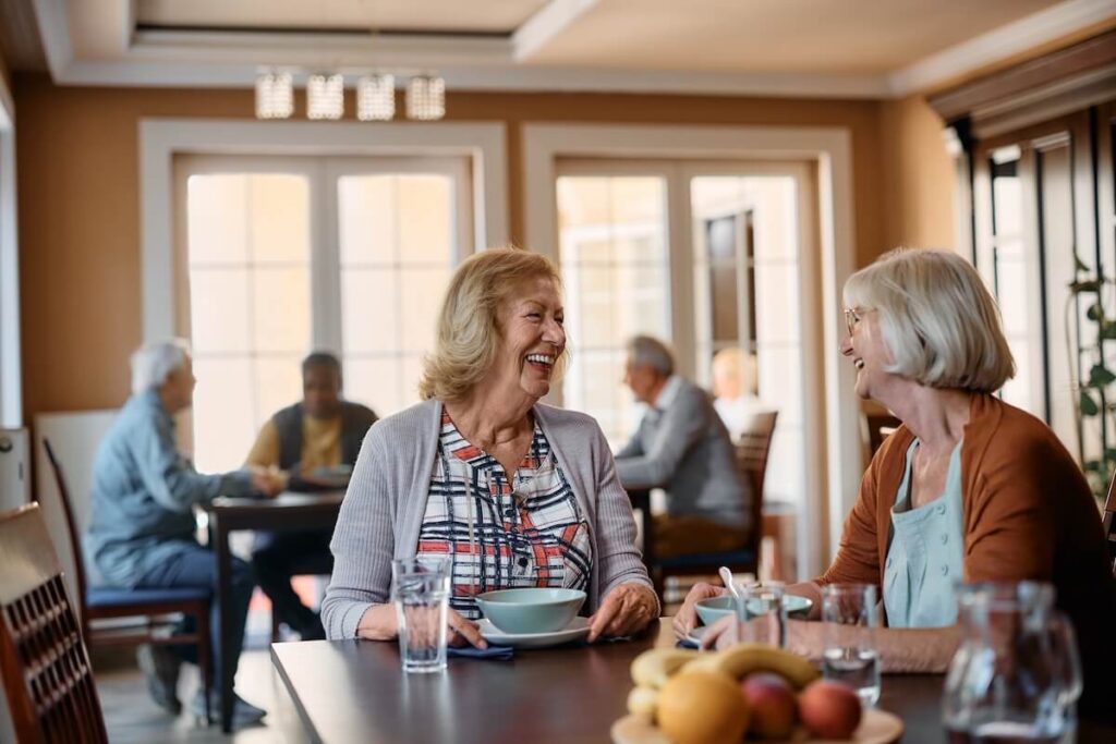 Happy seniors having a healthy meal in a community