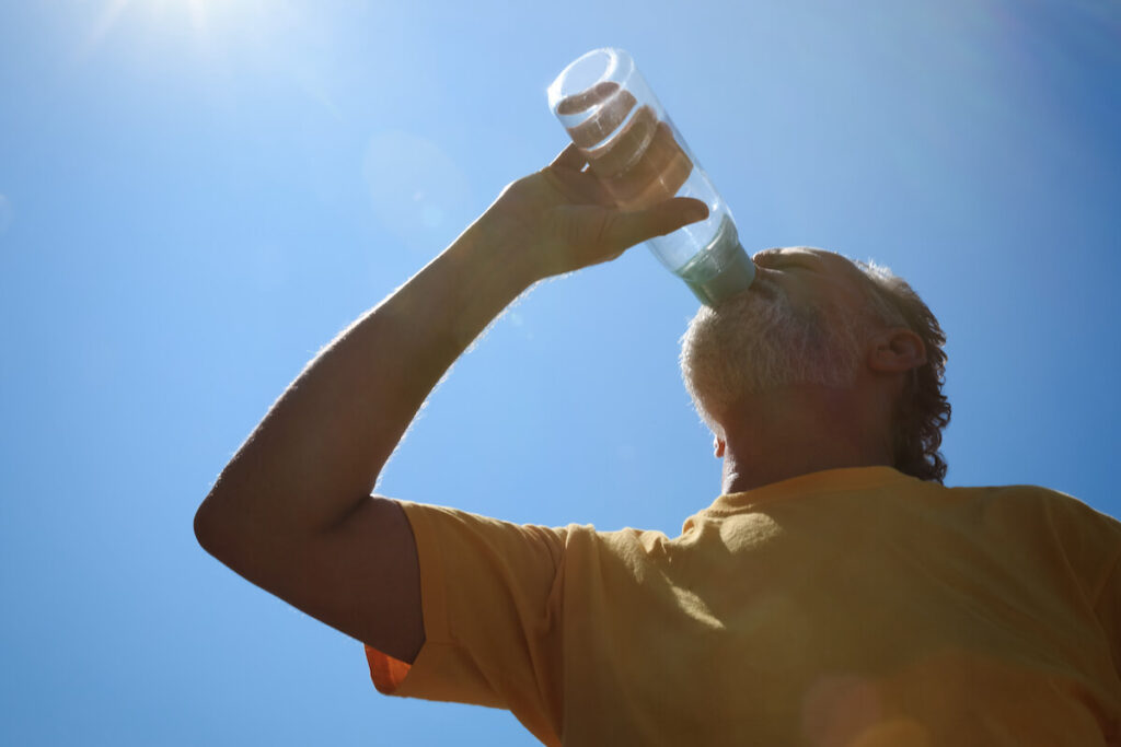 Older adult drinking water from a bottle