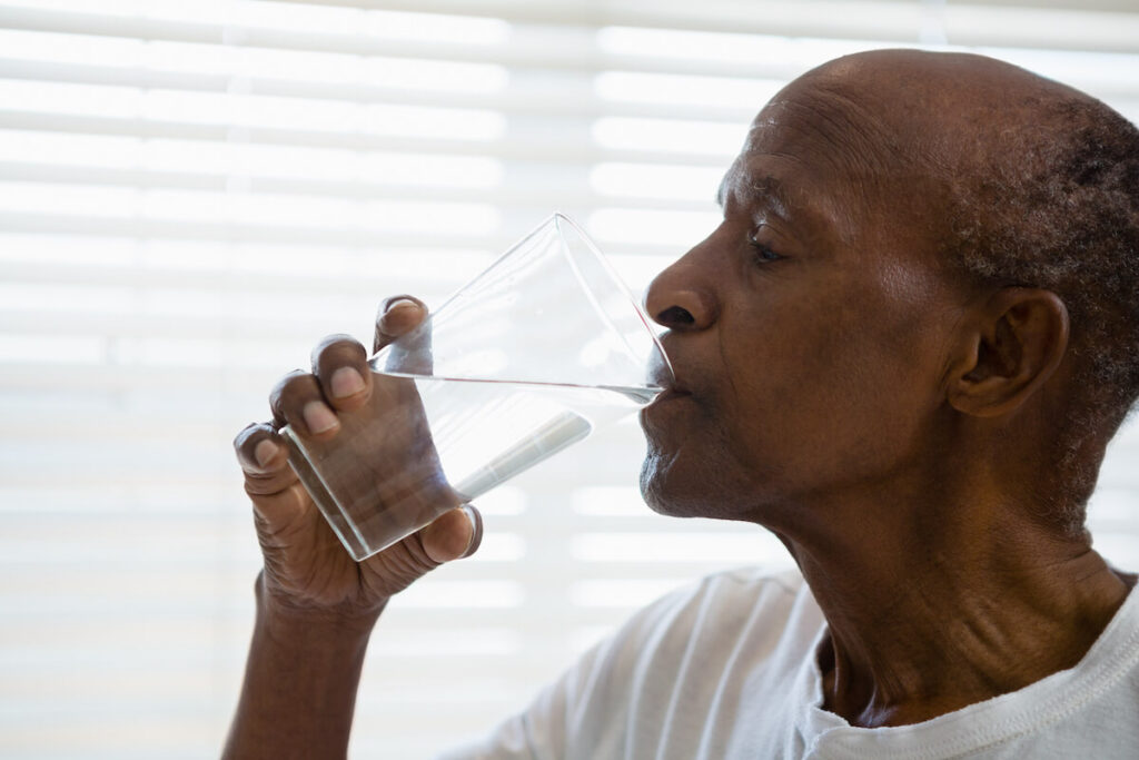 Senior Man Drinking Glass of Water