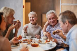 Group of older adults having a meal together