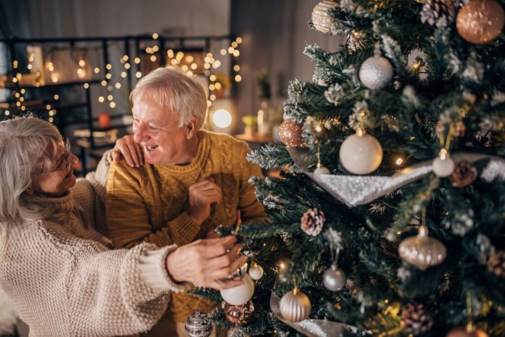 two older adults looking at a Christmas tree at windermere festival of trees 2025