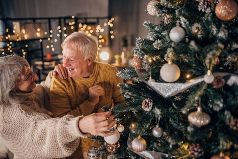 two older adults looking at a Christmas tree at windermere festival of trees 2025