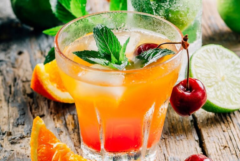 Cocktail at in a glass with mint and orange